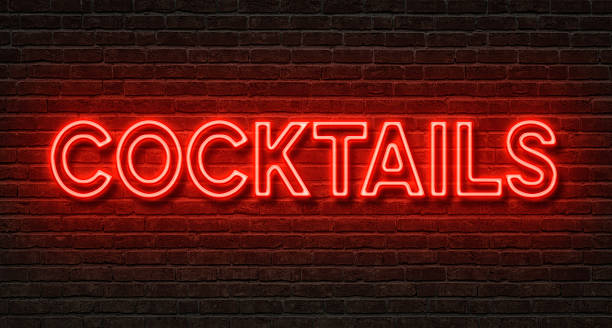 Neon sign on a brick wall - Cocktails Neon sign on a brick wall - Cocktails bar drink establishment photos stock pictures, royalty-free photos & images