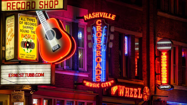 Neon Signs at Night on Broadway Street in Nashville, Tennessee Neon signs lit up at night on Broadway Street in Nashville, Tennessee broadway nashville stock pictures, royalty-free photos & images