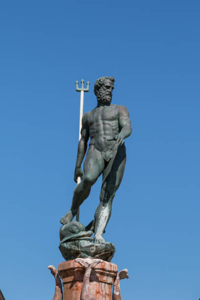 Neptune Bronze Statue with Trident Scepter and Blue Sky in background Neptune Bronze Statue with Trident Scepter and Blue Sky in background poseidon statue stock pictures, royalty-free photos & images