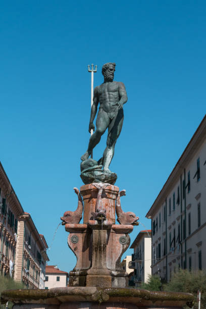 Neptune Bronze Statue with Trident Scepter and Blue Sky in background Neptune Bronze Statue with Trident Scepter and Blue Sky in background poseidon statue stock pictures, royalty-free photos & images