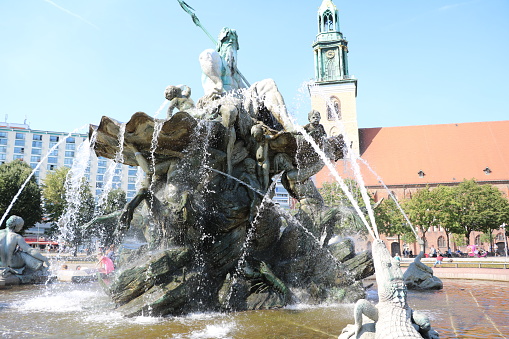 Neptune's Fountain and St. Mary's Church at Alexanderplatz in Berlin, Germany