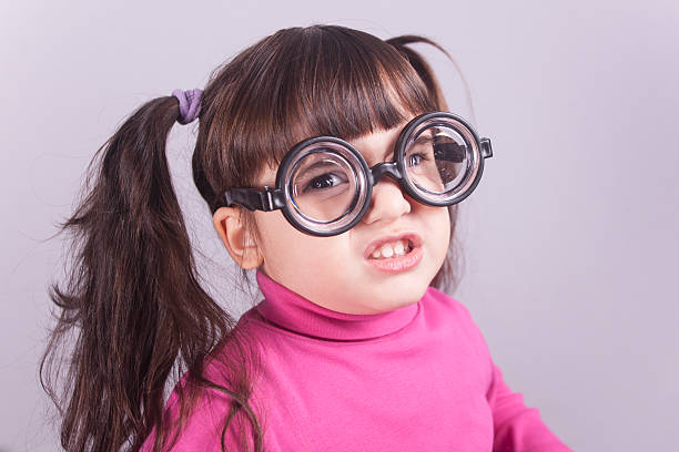 Nerdy little girl Funny nerdy little girl. Toned image with shallow depth of field ugly girl stock pictures, royalty-free photos & images
