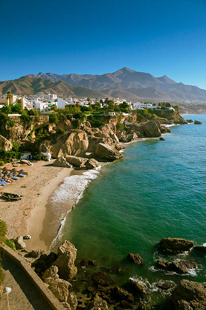 Nerja beach The beach in Nerja, Spain, on a beautiful morning. Sierra Nevada in the background. nerja stock pictures, royalty-free photos & images
