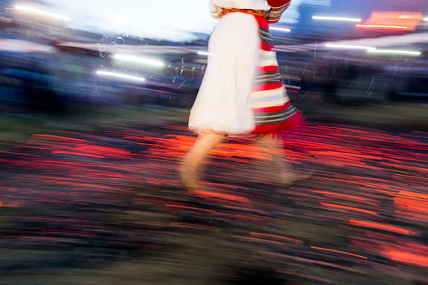 Nestinar woman walking on fire Nestinarstvo is a fire ritual originally performed in several Bulgarian and Greek  villages. It involves a barefoot dance on smouldering embers performed by nestinari. firewalking stock pictures, royalty-free photos & images