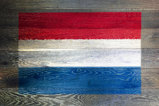 A Netherlands flag on rustic old wood surface background