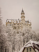 Schwangau, Germany - January 1, 2014: Neuschwanstein castle in winter as seen from Hohenschwangau Castle.