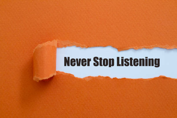 Never stop listening Never stop listening written under torn paper. wanted signal stock pictures, royalty-free photos & images
