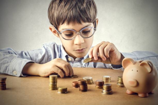 Never too young Little boy playing with coins allowance stock pictures, royalty-free photos & images