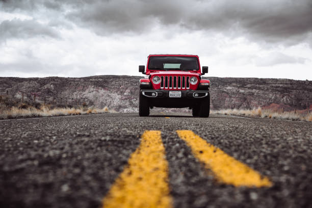 New 2019 Jeep Wrangler in Page city, Arizona Page, Arizona, United States - March 6, 2019: Photo of a Jeep Wrangler Sahara 2019 edition parked in the centre of the road in Page, Arizona on a cloudy day. It is the new wild offroad vehicle by Jeep. colorado plateau stock pictures, royalty-free photos & images