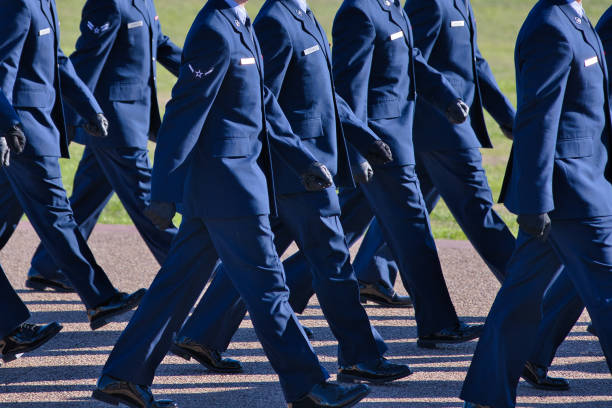 New Air Force members marching Air Force basic training graduation parade, new airmen in their dress blues marching in step. us air force stock pictures, royalty-free photos & images