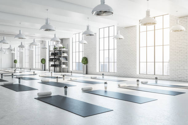New bright white yoga studio gym interior with brick wall, window and city view. 3D Rendering. stock photo