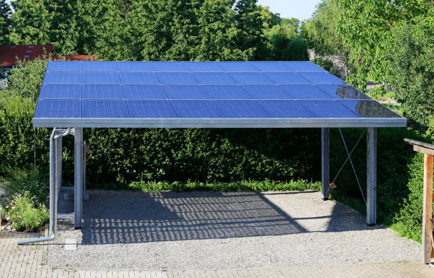 New carport with semi transparent photovoltaic module Modern semi-transparent photovoltaic modules made of glass replace the roof of a carport. Very long life with high efficiency and translucent material is the future for renewable energy. Own electricity for electric cars makes sense. solar energy photos stock pictures, royalty-free photos & images
