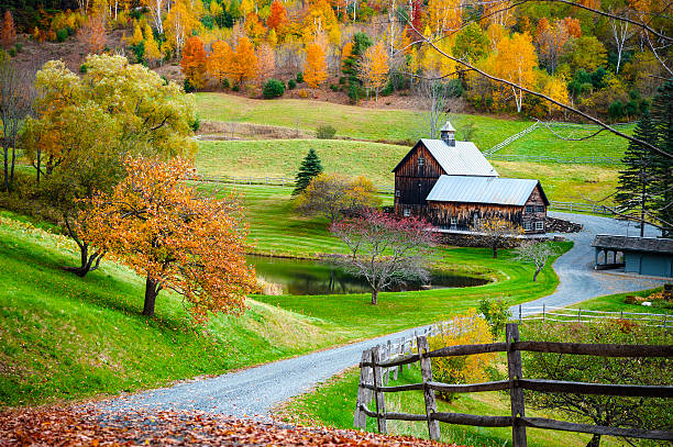 New England countryside, farm in autumn landscape Fall foliage, New England countryside at Woodstock, Vermont, farm in autumn landscape. Old wooden barn surrounded by colorful trees. new england states stock pictures, royalty-free photos & images