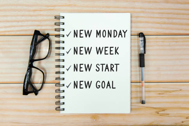 New Monday, New week, new start, new goal text on notebook stock photo