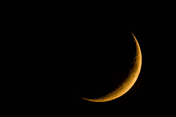 new moon on dark sky stock photo