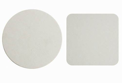 Image of two new beer coasters isolated on a white background. Add your own design or logo.