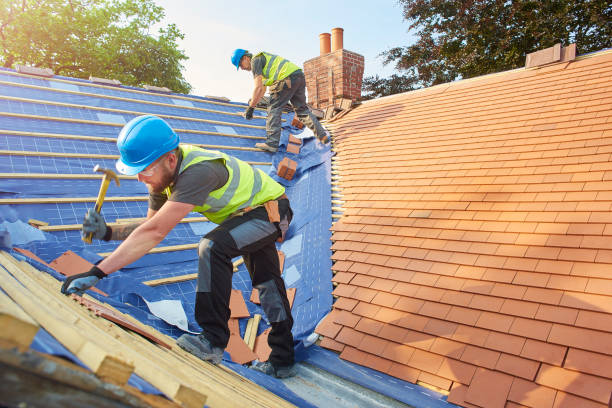 new roof installation a roofer nails on the roof tiles rooftop stock pictures, royalty-free photos & images