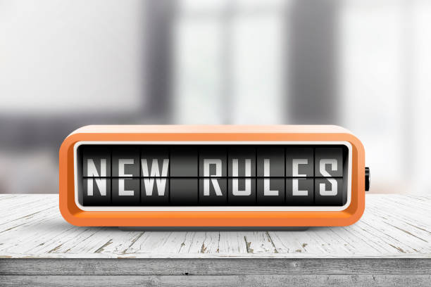 New rules alarm message on a wooden desk stock photo
