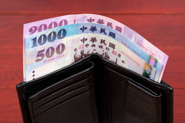 New Taiwan dollar in the black wallet stock photo
