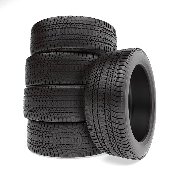 New tires stacked up and isolated on white background stock photo