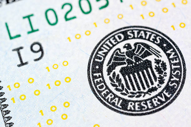 New US 2013 $100 Bill Federal Reserve Seal Extreme Macro An extreme macro image of the Federal Reserve seal on a new US 2013 $100 bill. Some microprinting is visible on the far left as 100s within the border. More Moneyhttp://www.banksphotos.com/LightboxBanners/Money.jpg federal reserve stock pictures, royalty-free photos & images