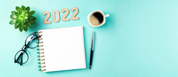 New year 2022 goals on desk. 2022 resolutions with open notebook, coffee cup, eyeglasses, plant succulent on green background. Goals, resolutions, plan, strategy, idea concept. New Year 2022 New year 2022 goals on desk. 2022 resolutions with open notebook, coffee cup, eyeglasses, plant succulent on green background. Goals, resolutions, plan, strategy, idea concept. New Year 2022 template new year's day stock pictures, royalty-free photos & images