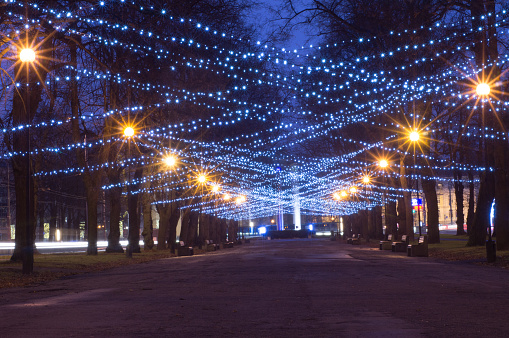 New Year and Christmas festoon illumination on city alley