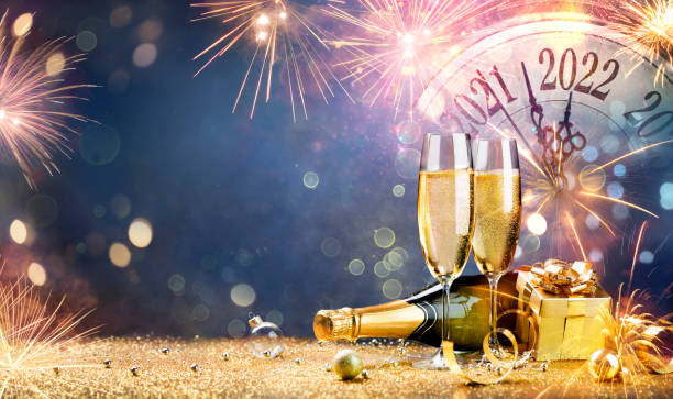 New Year Celebration 2022 - Champagne With Clock And Fireworks At Night stock photo