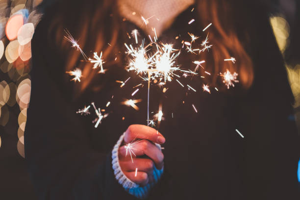 New Year celebration Happy woman at Christmas holding burning sparkler new years eve girl stock pictures, royalty-free photos & images