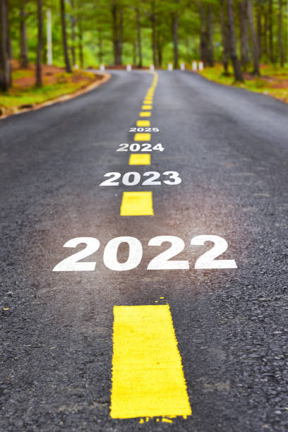 New year of 2022 2023 2024 and 2025 on asphalt road surface with marking lines stock photo