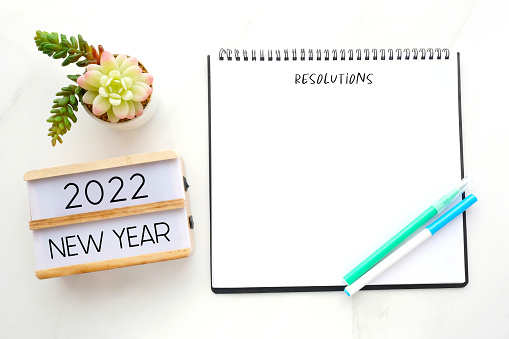 2022 new year on wood box, Resolution on blank notebook paper on white background, 2022 new year mock up, template, flat lay