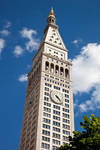 New York City Clock Tower from Madison Square Park. Shot taken in summer, blue sky puffy clouds in the background