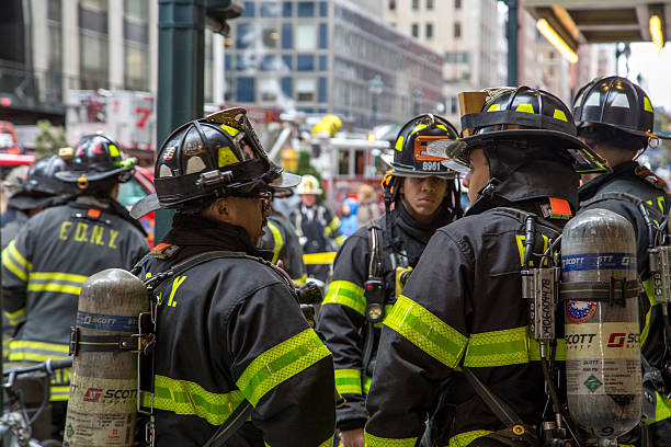 New York City Firemen and Truck New York, United States of America - November 20, 2016: Group of firemen waiting in front of the  Grand Central Market in Manhattan 911 new york stock pictures, royalty-free photos & images