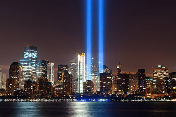 New York City skyline New York City downtown urban architecture at night and September 11 tribute light 911 remembrance stock pictures, royalty-free photos & images