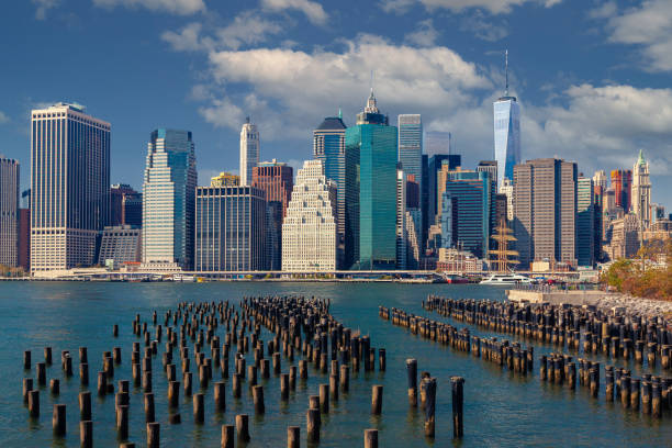 New York City Skyline with Manhattan Financial District, World Trade Center, East River and Blue Sky with Puffy Clouds. stock photo