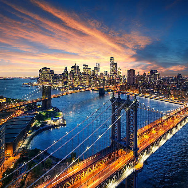 New York City sunset with manhattan and brooklyn bridge stock photo