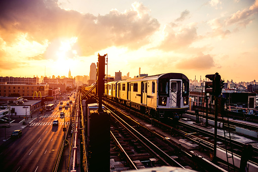 New York subway train approaching station platform in Queens