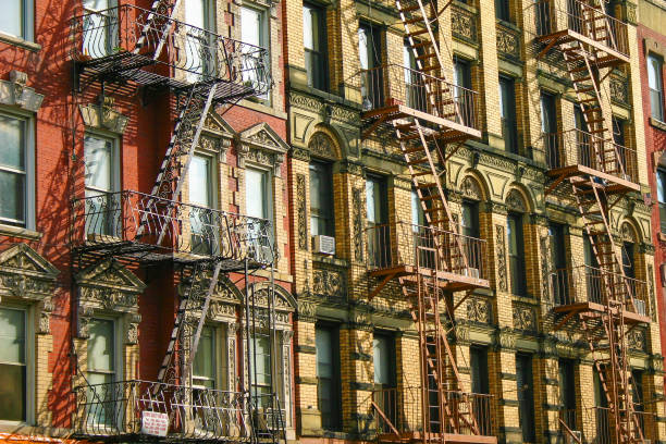 New York Typical Building Facades With Fire Escape Stairs stock photo