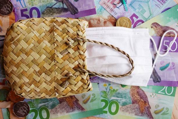 New Zealand Money (NZD) Dollars with Face Mask and a Flax Kete Purse stock photo