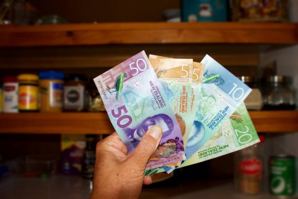 New Zealand Money (NZD) with Empty Food Cupboard stock photo