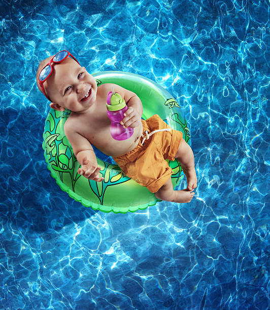 Newborn Baby Boy Floating on an Inner Tube stock photo