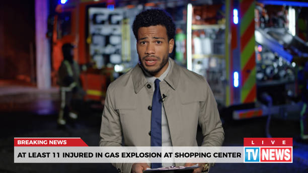 News reporter reporting on gas explosion Male news reporter reporting on gas explosion at shopping centre during night. breaking news stock pictures, royalty-free photos & images