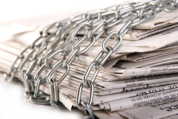 newspapers pile of newspapers with metal chain censorship stock pictures, royalty-free photos & images