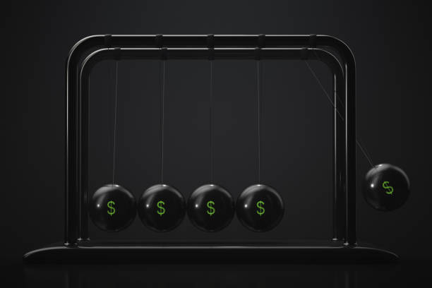 Newton's cradle with American currency symbols stock photo