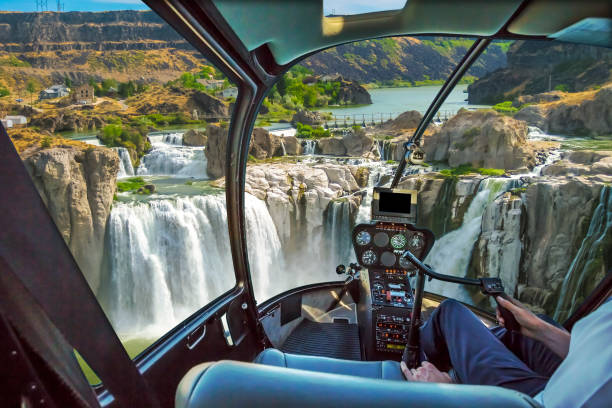 Niagara Falls Helicopter Helicopter cockpit with pilot arm and control console inside the cabin in aerial view flight on Shoshone Falls or Niagara of the West, Snake River, Idaho, United States. niagara falls stock pictures, royalty-free photos & images
