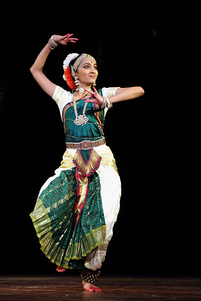 Nidhi Ravishankar - Bharatanatyam Bangalore, India - August 3, 2014: Nidhi Ravishankar, a young girl performs bharatanatyam recital at JSS auditorium for the first time in an event organised by her father Mr.Ravishankar. She began to practice classical dance since her childhood. Miss Nidhi enters the Rangapravesha / Arangetram, an occassion (a traditional practice in South India) in which she is introduced to the people through a stage performance for the first time by her master or guru generally after few years of practice. bharathanatyam stock pictures, royalty-free photos & images