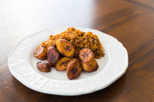 Nigerian Brown Beans Pottage ( Ewa Agoyin ) with Plantain stock photo