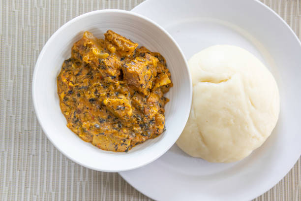 Nigerian Pounded Yam served with Spicy Bitter leaf soup stock photo