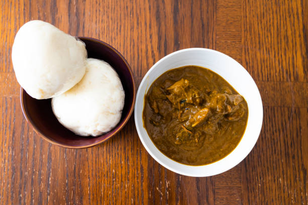 Nigerian Pounded yam wrapped in plastic served with Banga Soup stock photo