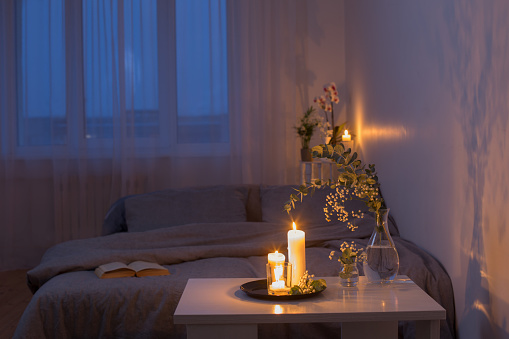 Night Interior Of Bedroom With Flowers And Burning Candles Stock Photo - Download Image Now - iStock